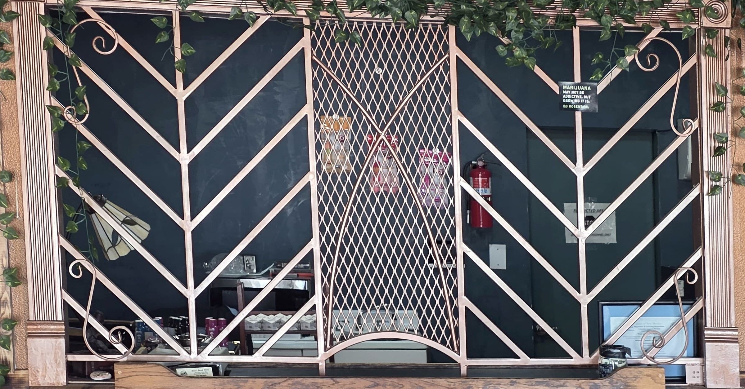 Ornate copper grate at the service counter inside Weed and Read