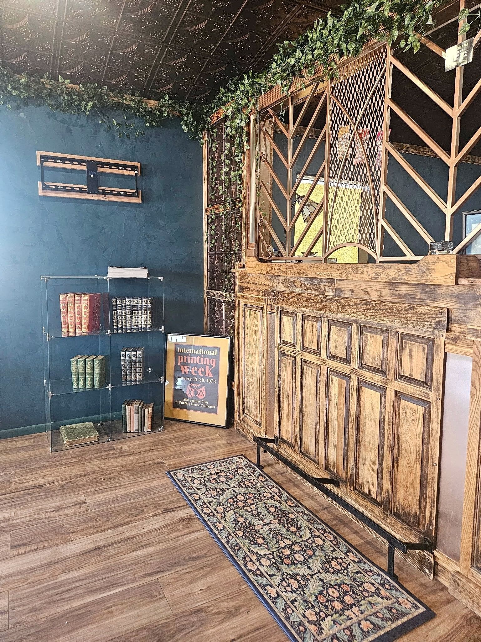 Vintage wood teller counter and book shelf inside Weed and Read